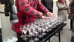 Street artist playing Hallelujah with crystal glasses