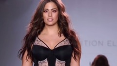 Plus-size model Ashley Graham showcases her curves in black lace underwear on the runway